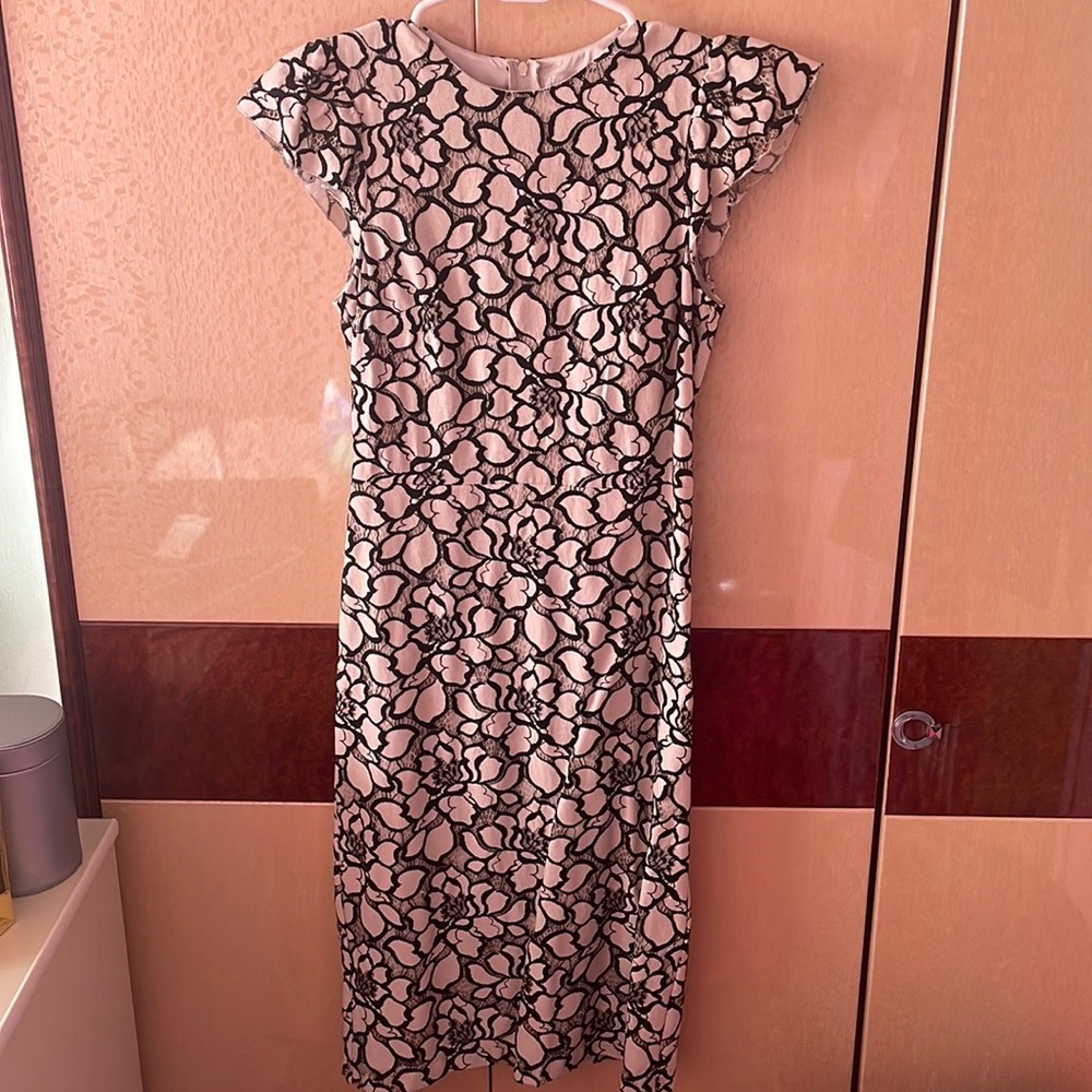 White dress with black floral and lace design. Size 4